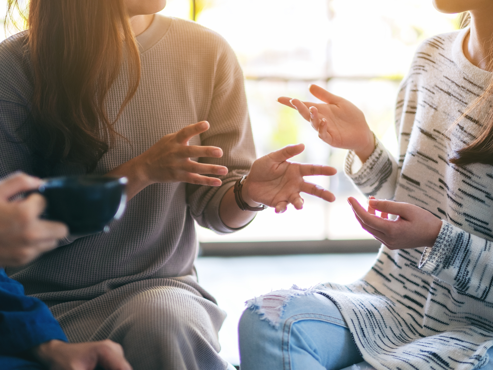 Tenants sitting down holding out hands to express what they are saying 