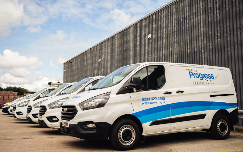 Progress housing work vans parked next to each other 